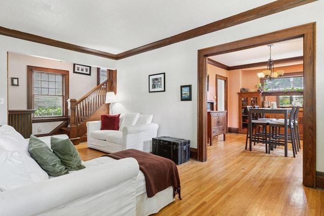 1756 Minnehaha Ave W, Saint Paul, MN 55104 - living area featuring a chandelier, light wood-style flooring, ornamental molding, plenty of natural light, and stairway