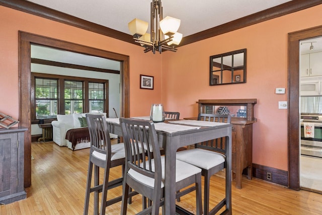 1756 Minnehaha Ave W, Saint Paul, MN 55104 - dining space with a chandelier, crown molding, and light wood-type flooring