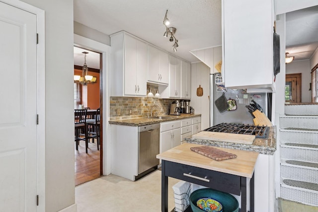 1756 Minnehaha Ave W, Saint Paul, MN 55104 - kitchen featuring dishwasher, white cabinets, backsplash, a chandelier, and gas stovetop