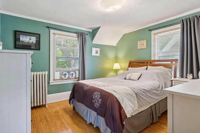 1756 Minnehaha Ave W, Saint Paul, MN 55104 - bedroom featuring radiator, a textured ceiling, light wood-style floors, multiple windows, and crown molding