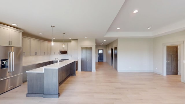 2334 9th St W, Albert Lea, MN 56007 - kitchen with appliances with stainless steel finishes, recessed lighting, light countertops, a center island with sink, and light wood finished floors