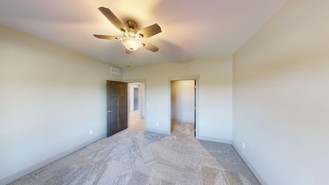 2334 9th St W, Albert Lea, MN 56007 - unfurnished bedroom with light colored carpet, a spacious closet, and a ceiling fan