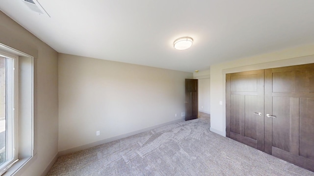2334 9th St W, Albert Lea, MN 56007 - unfurnished bedroom with carpet floors, a closet, and multiple windows