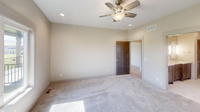 2334 9th St W, Albert Lea, MN 56007 - unfurnished bedroom featuring light carpet, ensuite bathroom, recessed lighting, and a ceiling fan