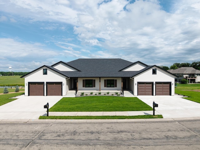 2334 9th St W, Albert Lea, MN 56007 - modern farmhouse style home with concrete driveway, a garage, a front lawn, and a shingled roof