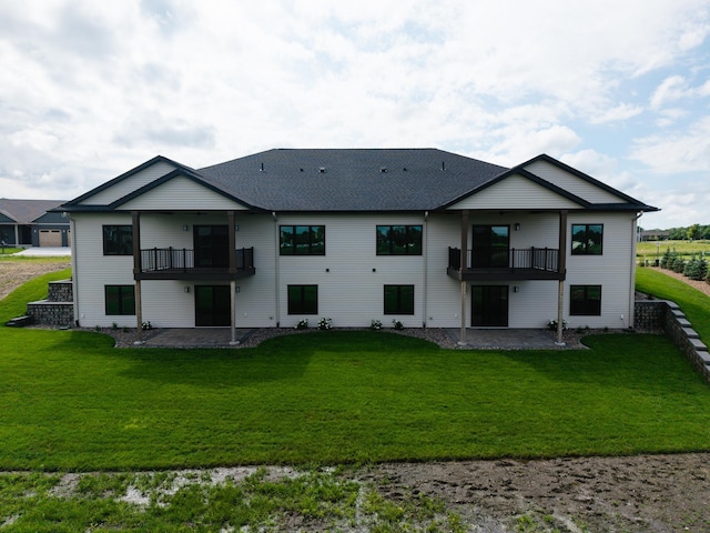 2334 9th St W, Albert Lea, MN 56007 - back of house with a balcony, a patio, and a lawn