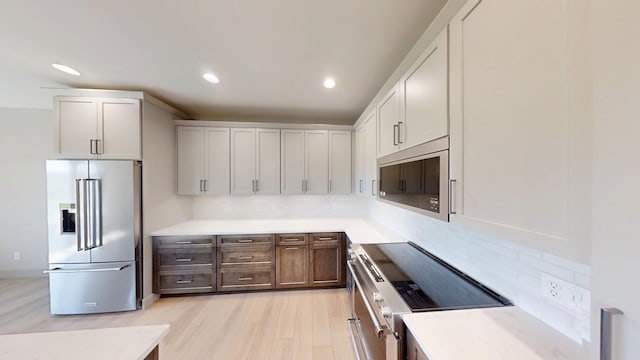 2334 9th St W, Albert Lea, MN 56007 - kitchen featuring stainless steel appliances, tasteful backsplash, recessed lighting, light countertops, and light wood finished floors