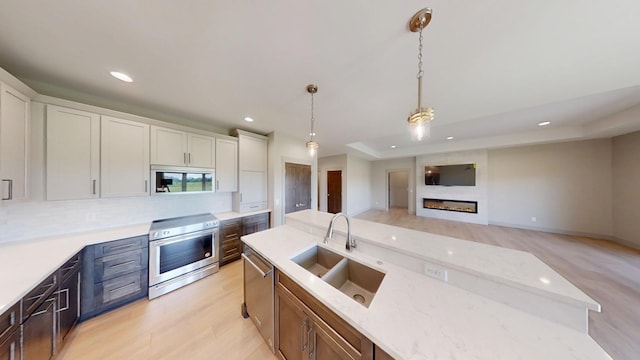 2334 9th St W, Albert Lea, MN 56007 - kitchen featuring appliances with stainless steel finishes, recessed lighting, pendant lighting, a fireplace, and white cabinets