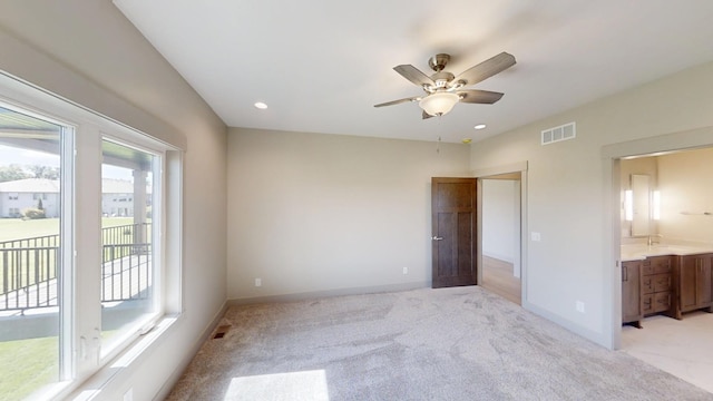 2334 9th St W, Albert Lea, MN 56007 - unfurnished bedroom featuring access to outside, light colored carpet, recessed lighting, ensuite bathroom, and a ceiling fan