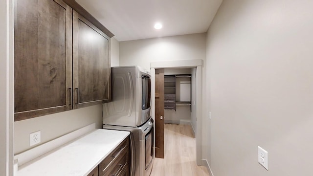 2334 9th St W, Albert Lea, MN 56007 - laundry area featuring cabinet space, stacked washing machine and dryer, and light wood finished floors