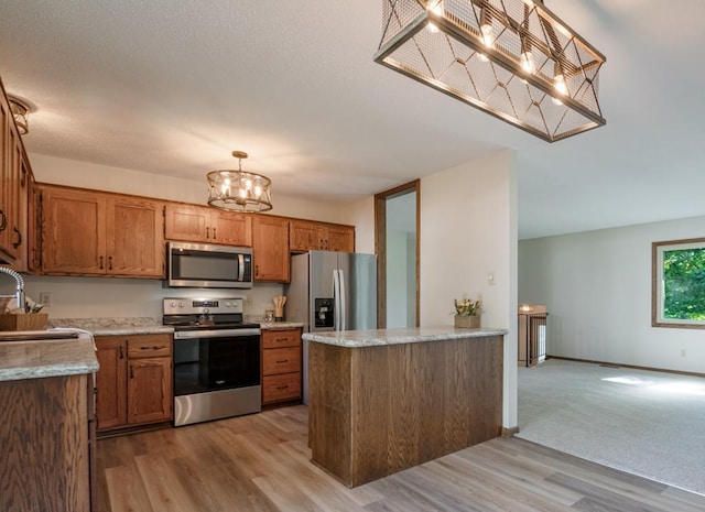 5445 Large Ave NE, Albertville, MN 55301 - kitchen featuring appliances with stainless steel finishes, brown cabinets, light countertops, and light wood-type flooring