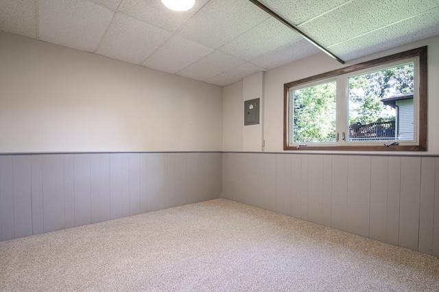 5445 Large Ave NE, Albertville, MN 55301 - carpeted spare room with wainscoting, a paneled ceiling, electric panel, and wood walls