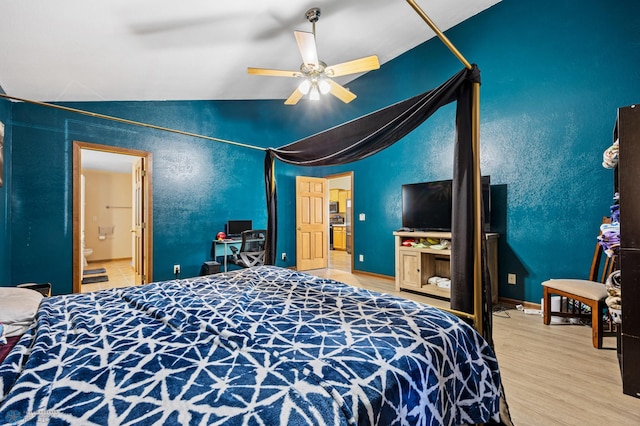 362 5th Ave N, Casselton, ND 58012 - bedroom with vaulted ceiling, wood finished floors, ceiling fan, and ensuite bath