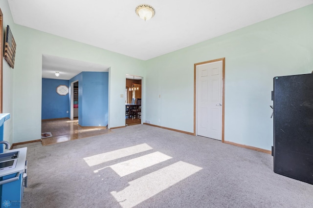 362 5th Ave N, Casselton, ND 58012 - unfurnished living room featuring carpet and baseboards