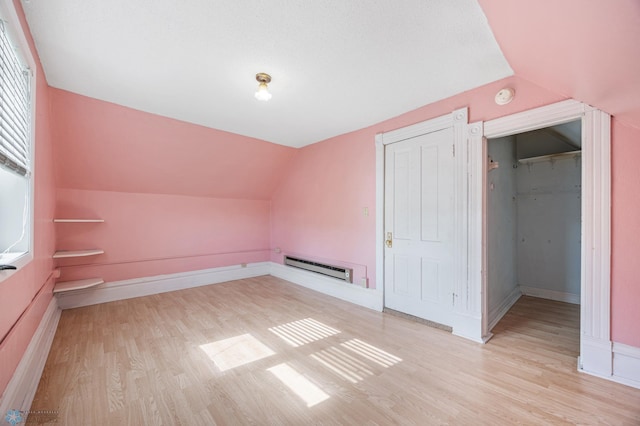362 5th Ave N, Casselton, ND 58012 - bonus room featuring vaulted ceiling, baseboard heating, and light wood-type flooring