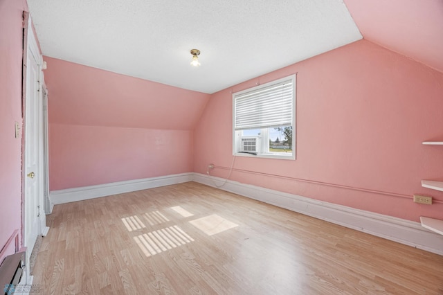 362 5th Ave N, Casselton, ND 58012 - additional living space with lofted ceiling, wood finished floors, and baseboard heating