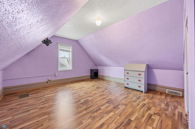 362 5th Ave N, Casselton, ND 58012 - bonus room with a textured ceiling, wood finished floors, and vaulted ceiling