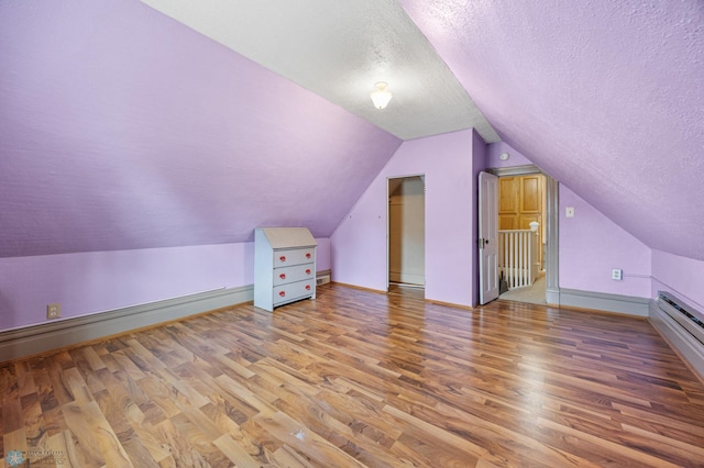 362 5th Ave N, Casselton, ND 58012 - additional living space featuring a textured ceiling, light wood finished floors, and lofted ceiling