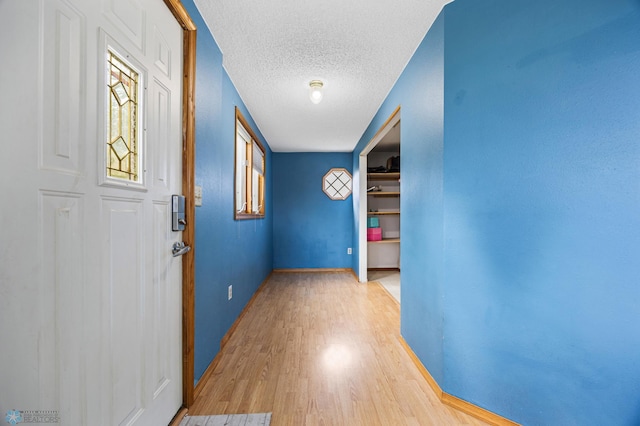 362 5th Ave N, Casselton, ND 58012 - hall with light wood finished floors and a textured ceiling