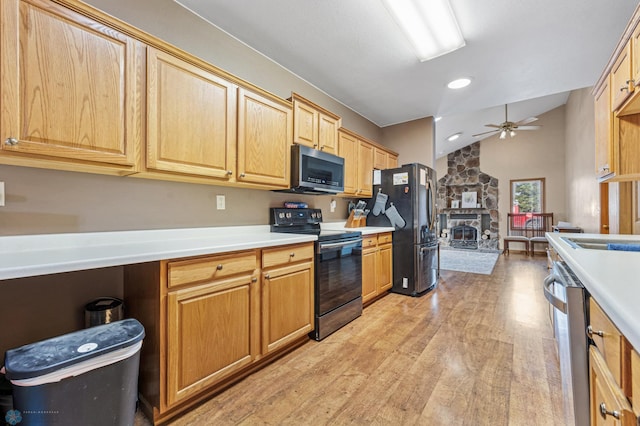 362 5th Ave N, Casselton, ND 58012 - kitchen with stainless steel appliances, ceiling fan, light wood finished floors, vaulted ceiling, and light countertops