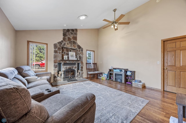 362 5th Ave N, Casselton, ND 58012 - living room featuring wood finished floors, ceiling fan, a stone fireplace, and high vaulted ceiling