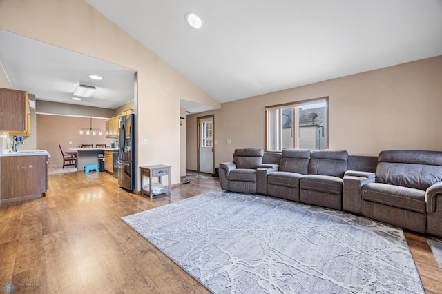 362 5th Ave N, Casselton, ND 58012 - living room featuring light wood finished floors and vaulted ceiling