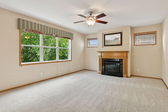 1767 Switchgrass Ct, Shakopee, MN 55379 - unfurnished living room featuring carpet flooring, a fireplace with flush hearth, and a ceiling fan