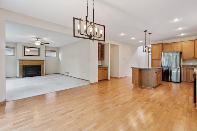1767 Switchgrass Ct, Shakopee, MN 55379 - kitchen with freestanding refrigerator, a ceiling fan, a center island, light wood finished floors, and recessed lighting