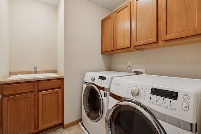 1767 Switchgrass Ct, Shakopee, MN 55379 - laundry area with washing machine and dryer, cabinet space, a textured ceiling, and light tile patterned floors