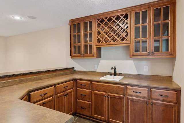 1767 Switchgrass Ct, Shakopee, MN 55379 - kitchen with glass insert cabinets, brown cabinets, and dark tile patterned flooring