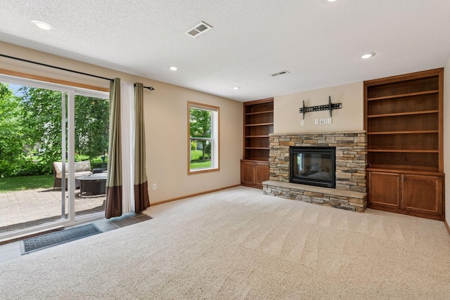 1767 Switchgrass Ct, Shakopee, MN 55379 - unfurnished living room with a fireplace, carpet flooring, a textured ceiling, built in features, and recessed lighting