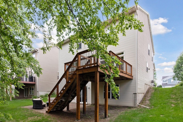 1767 Switchgrass Ct, Shakopee, MN 55379 - rear view of house featuring a lawn, a wooden deck, an outdoor fire pit, and stairway