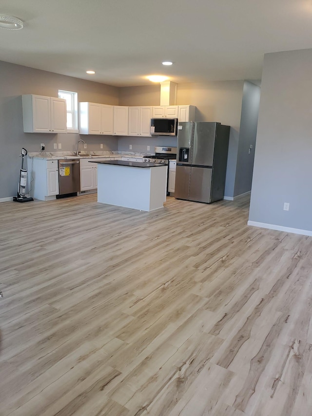 1884 Ames Ave, Saint Paul, MN 55119 - kitchen featuring appliances with stainless steel finishes, light wood-style floors, white cabinetry, recessed lighting, and a center island
