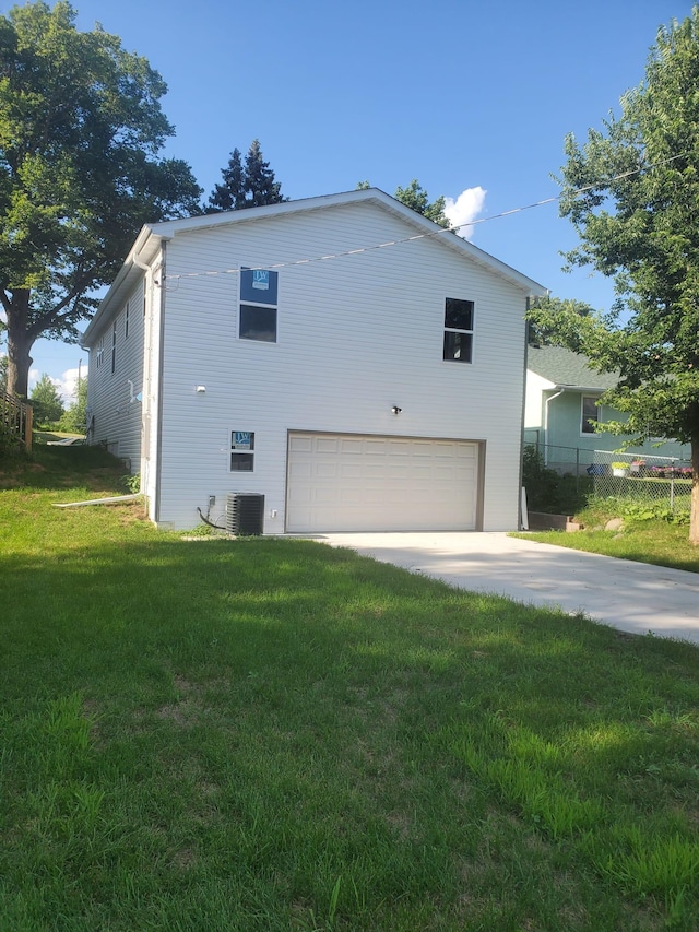 1884 Ames Ave, Saint Paul, MN 55119 - view of side of home featuring an attached garage and concrete driveway