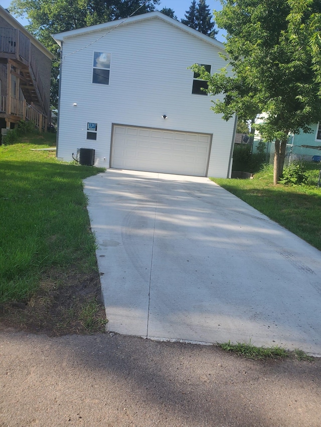 1884 Ames Ave, Saint Paul, MN 55119 - view of side of property featuring driveway, an attached garage, and a lawn