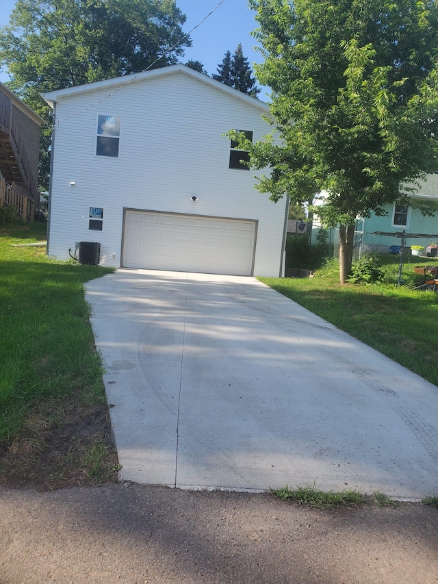 1884 Ames Ave, Saint Paul, MN 55119 - view of home's exterior with an attached garage, concrete driveway, and a lawn