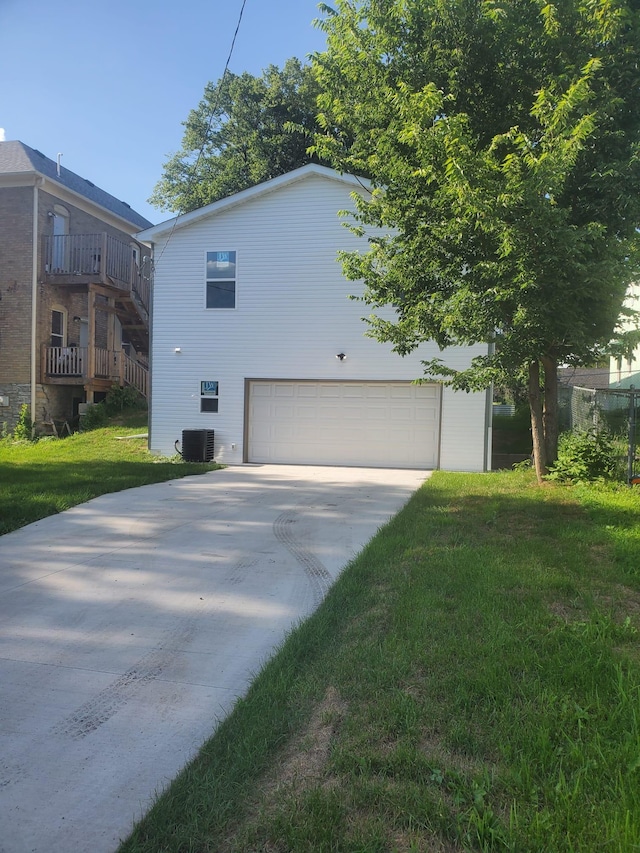 1884 Ames Ave, Saint Paul, MN 55119 - view of side of property featuring concrete driveway, a garage, and a yard