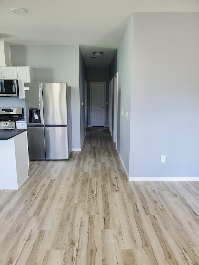 1884 Ames Ave, Saint Paul, MN 55119 - kitchen featuring appliances with stainless steel finishes, light wood-type flooring, white cabinets, and dark countertops