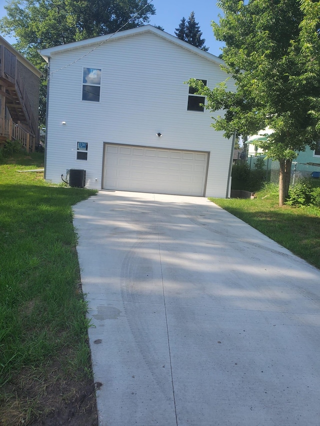 1884 Ames Ave, Saint Paul, MN 55119 - view of front of house with concrete driveway, an attached garage, and a front yard