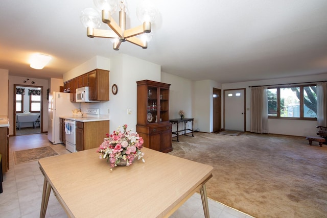 608 Pfau St, Mankato, MN 56001 - dining area featuring a chandelier and light colored carpet