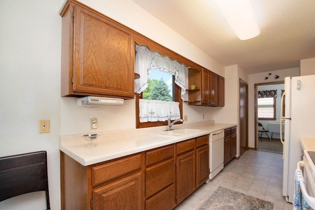 608 Pfau St, Mankato, MN 56001 - kitchen with white appliances, light countertops, and brown cabinetry