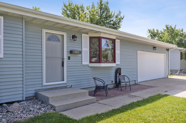 901 7th St W, West Fargo, ND 58078 - property entrance with a garage and concrete driveway