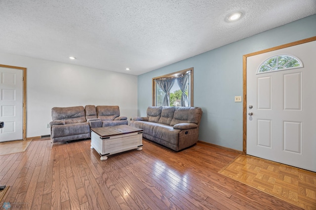 901 7th St W, West Fargo, ND 58078 - living area featuring a textured ceiling and light wood-style flooring