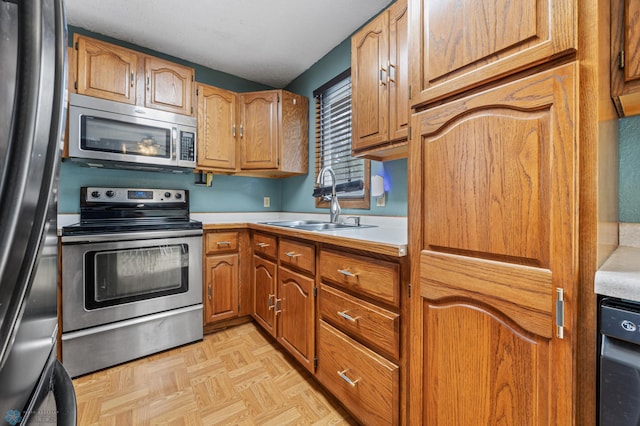 901 7th St W, West Fargo, ND 58078 - kitchen with stainless steel appliances, light countertops, and brown cabinets