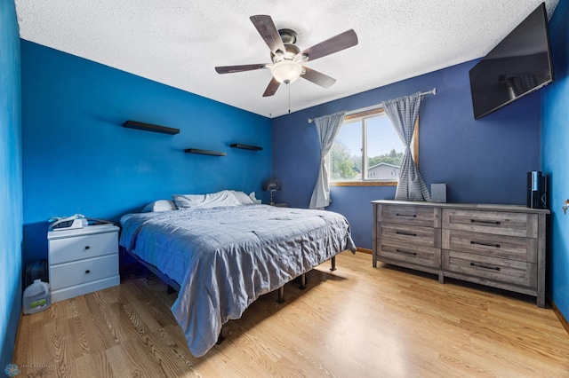 901 7th St W, West Fargo, ND 58078 - bedroom featuring wood finished floors, a textured ceiling, and ceiling fan