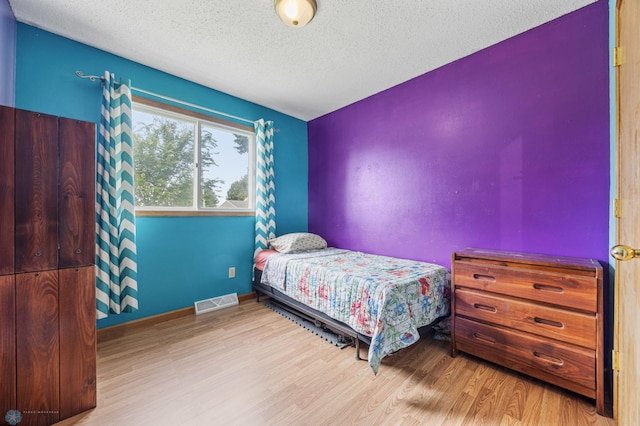901 7th St W, West Fargo, ND 58078 - bedroom with wood finished floors and a textured ceiling