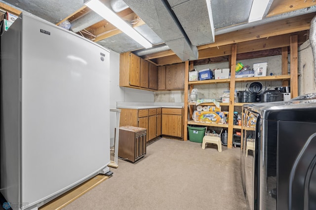 901 7th St W, West Fargo, ND 58078 - unfinished basement with freestanding refrigerator, light colored carpet, and washer / dryer