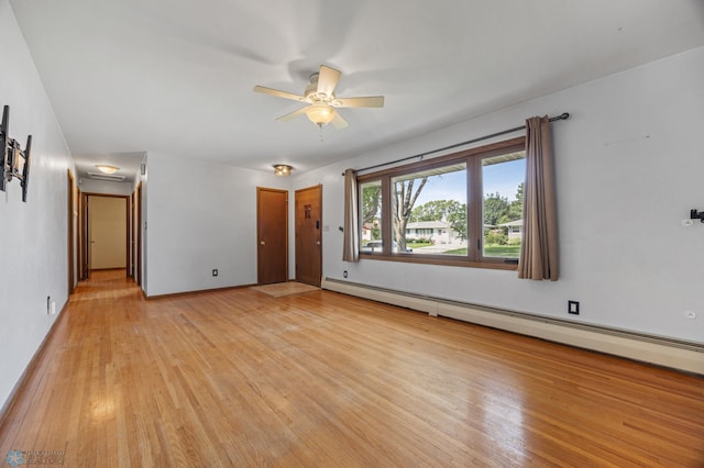 3113 8th St N, Fargo, ND 58102 - spare room with a baseboard radiator, light wood finished floors, and a ceiling fan