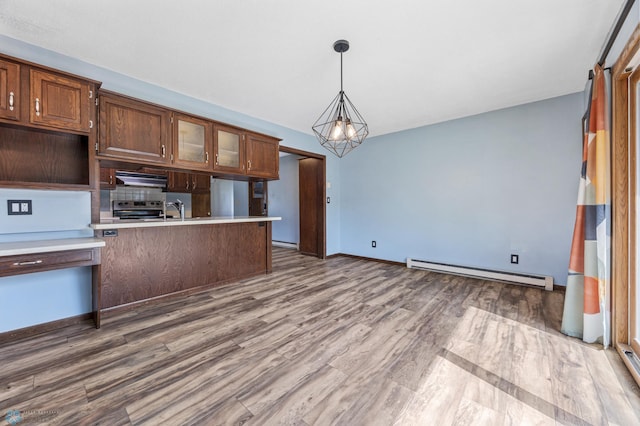3113 8th St N, Fargo, ND 58102 - kitchen with a baseboard heating unit, stainless steel range with electric stovetop, light countertops, and hanging light fixtures