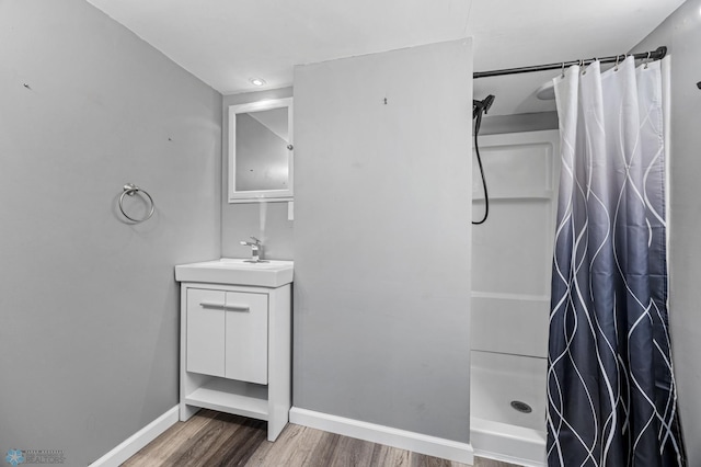 3113 8th St N, Fargo, ND 58102 - full bath with wood finished floors, vanity, and a shower with shower curtain